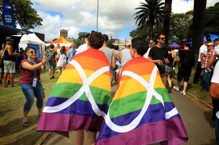Draped in the rainbow flag and enjoying the atmosphere at the Mardi Gras fair day on February 22 in Sydney. Photo by James Alcock/Fairfax Media