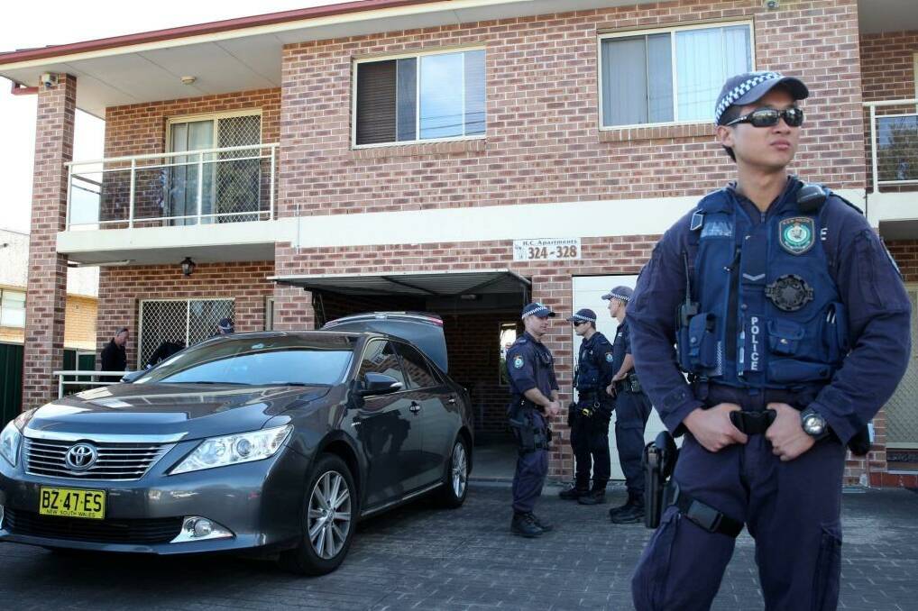 NSW Police during raids on houses in western Sydney this week. Photo: Edwina Pickles