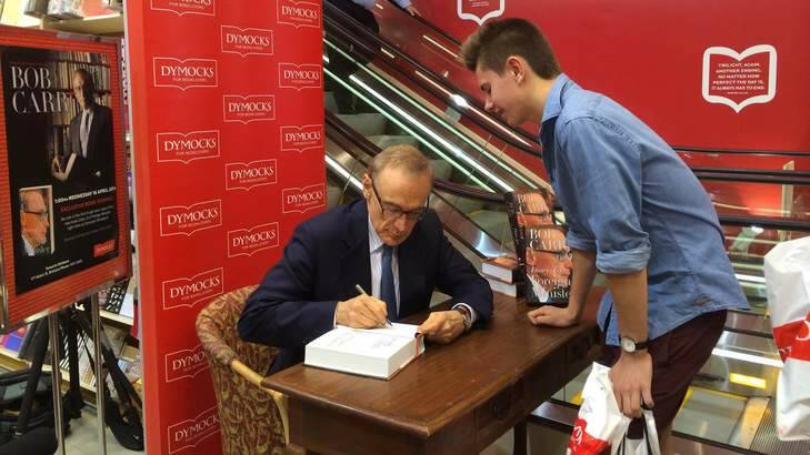 Bob Carr signs copies of his new book, Diary of a Foreign Minister, at Dymocks in Brisbane City on Wednesday. Photo: Natalie Bochenski