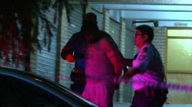 Shahab Ahmed, 33, is lead away by police after his wife was stabbed in Parramatta. Photo: Nine News