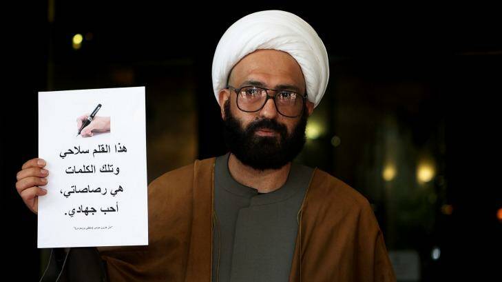 Man Haron Monis holds a sign outside the Downing Centre courts, where he was appearing in relation to sending hate mail to the families of fallen Australian soldiers, in 2010. Photo: Kate Geraghty