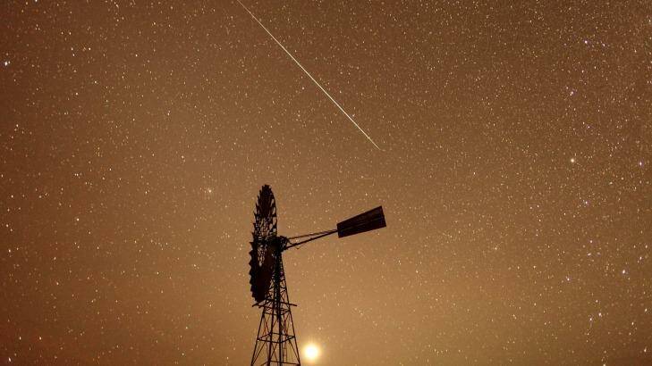 A meteor burns up in the atmosphere over the Spell Bore Yards in the Northern Territory last year. Photo: Glenn Campbell