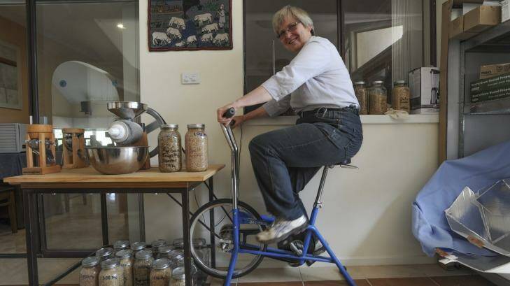 Feet to the grindstone: Cindy Steensby exercises her right to organic milling. Photo: Graham Tidy