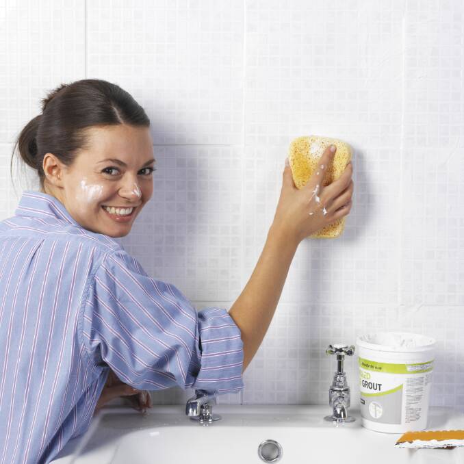 Woman scrubbing bathroom wall Home Inspirations wrapDIYGive your bathroom a beautiful makeover