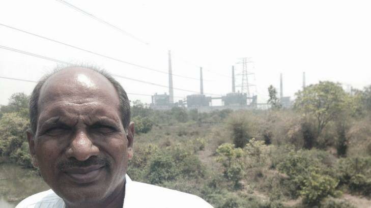 Suresh Chopne, founder of Green Planet, in front of a coal fired power station built on the edge of Chandrapur.