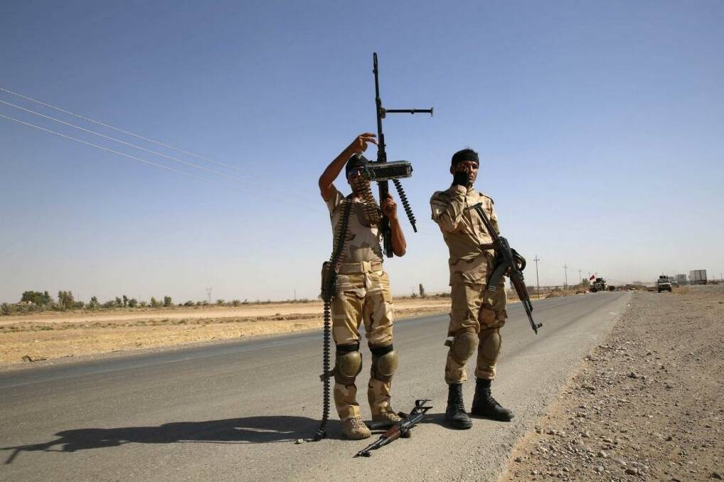 Fighters from the Shi'ite Badr Brigade militia set up a mobile checkpoint in Suleiman Beg, northern Iraq. Photo:  Reuters