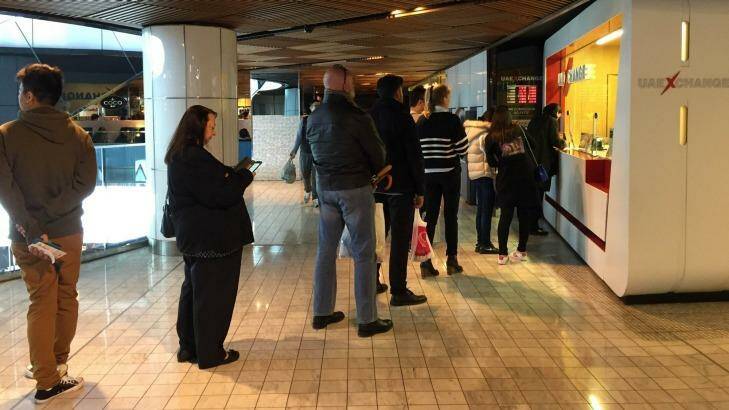 People queue at a currency exchange store in central Sydney to get their hands on pounds. Photo: Sophia Phan