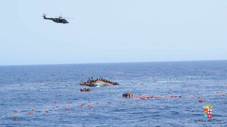 A migrant boat capsizes in the Mediterranean in full view of the Italian Navy which rushed to its rescue. Photo: Marina Militare