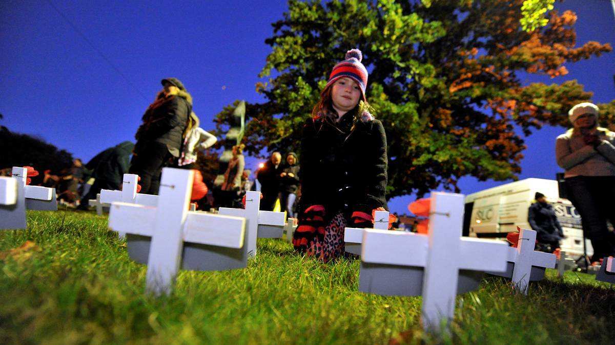 BALLARAT: Amelie Stott finds the crosses of her great great uncles. Photo: Jeremy Bannister, The Courier.