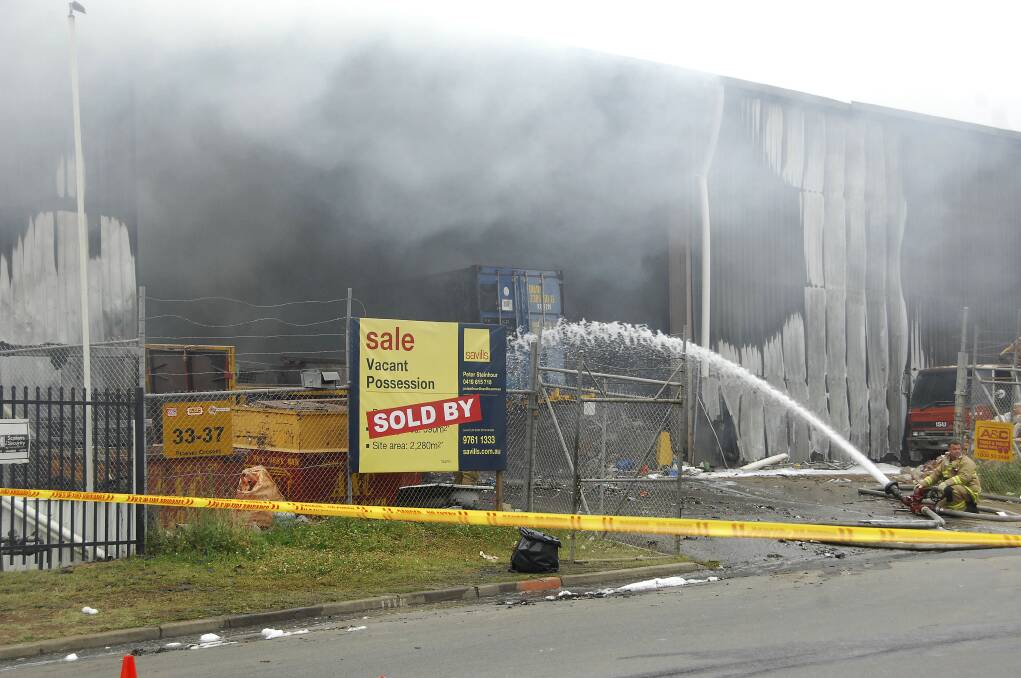 Factory fire: Fire crews this morning still attending to the rubbish recycling factory. Picture: Michael Szabath
