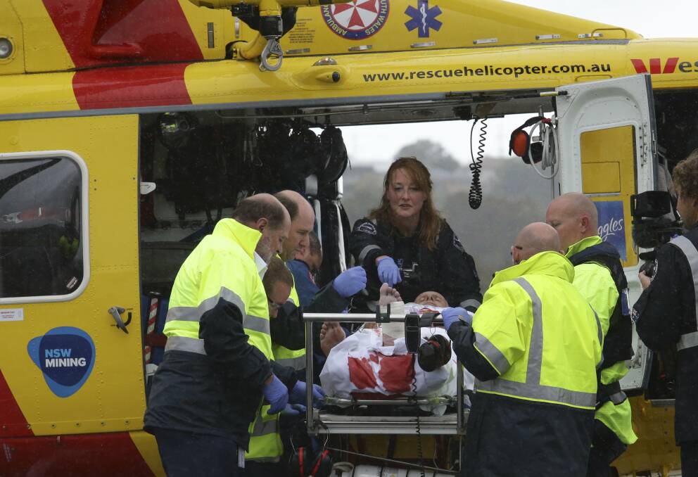 The surfer arrives at the John Hunter Hospital after being bitten by a shark. Pic: Peter Stoop 