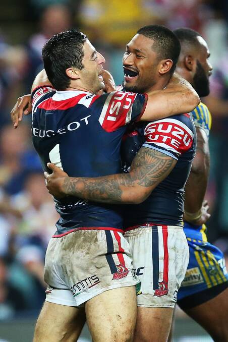 SYDNEY, AUSTRALIA - MARCH 15: Anthony Minichello of the Roosters celebrates with team mate Frank Paul Nuuausala after scoring his third try during the round two NRL match between the Sydney Roosters and the Parramatta Eels at Allianz Stadium on March 15, 2014 in Sydney, Australia. (Photo by Brendon Thorne/Getty Images)